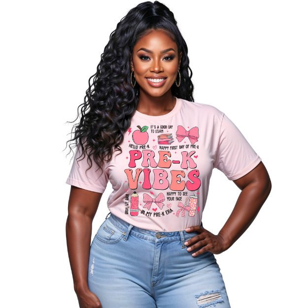 Woman wearing a pink 'Pre-K Vibes' t-shirt with text and graphics.