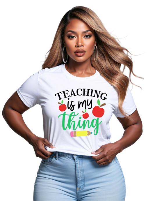 Woman wearing a white t-shirt with 'Teaching is my thing' text and graphics on a gray background